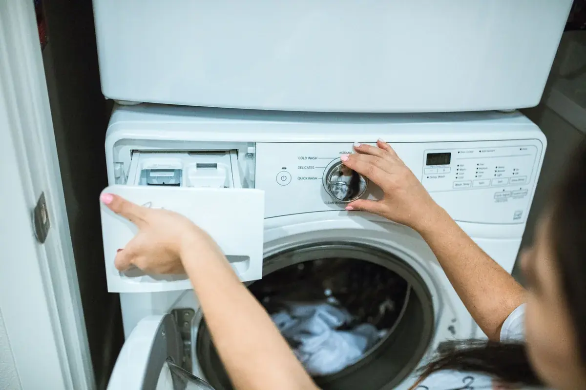 Open detergent drawer on a front-loading washing machine.